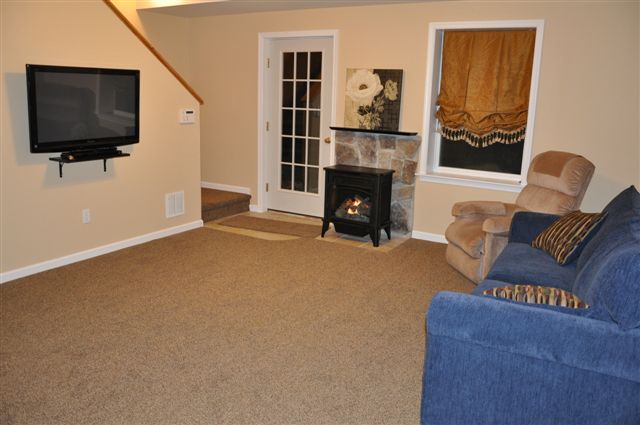 Lower level den with flat screen TV, DVD, and gas fireplace.
