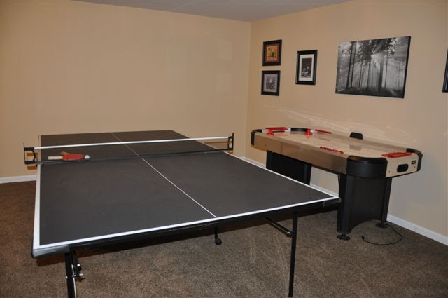 Ping pong table and air hockey located in lower level game room.